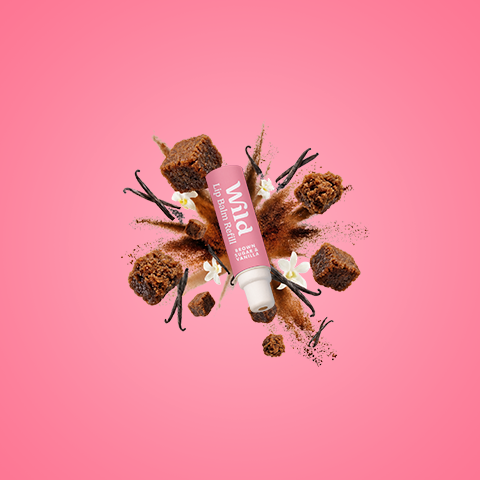 Caption: a tube of lip butter sitting on top of a pink background