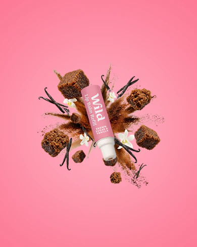Caption: a tube of lip butter sitting on top of a pink background