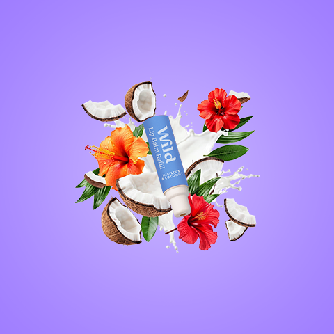 Caption: a tube of toothpaste surrounded by flowers and coconuts