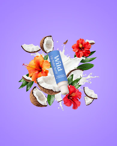 Caption: a tube of toothpaste surrounded by flowers and coconuts