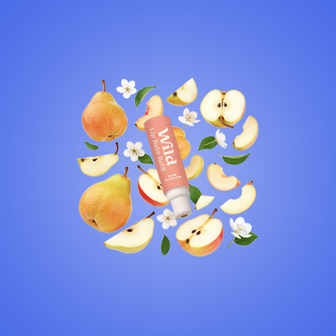 Caption: a tube of lip balm surrounded by apples and flowers