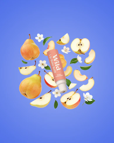Caption: a tube of lip balm surrounded by apples and flowers