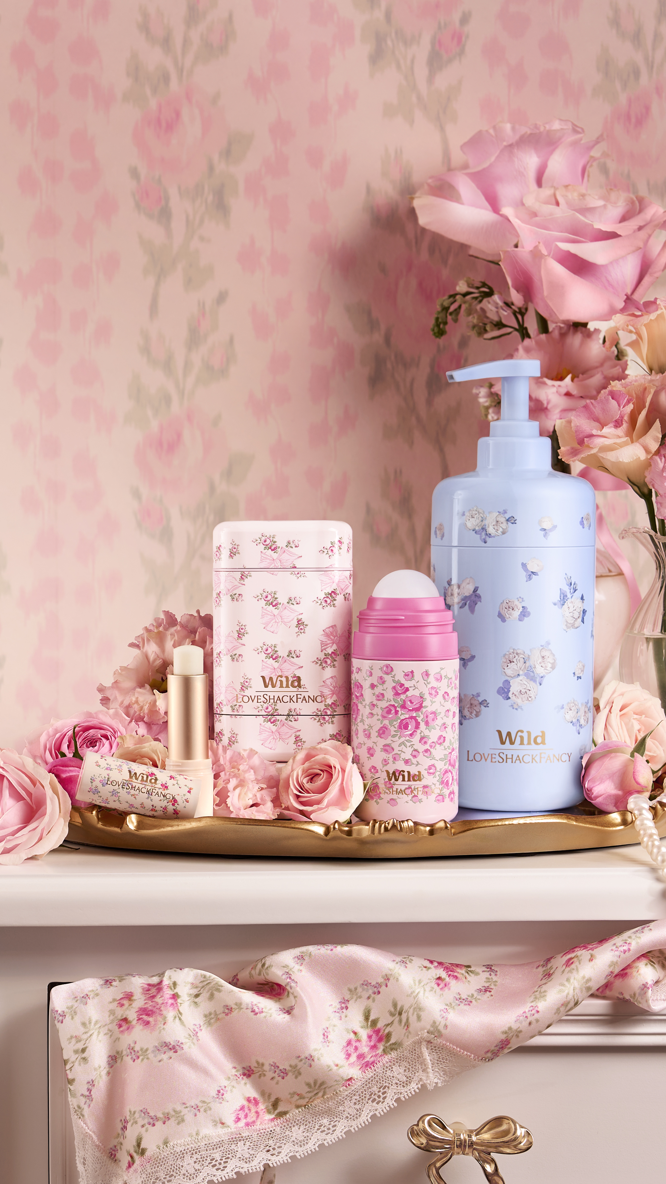 Caption: a white dresser topped with lots of pink flowers