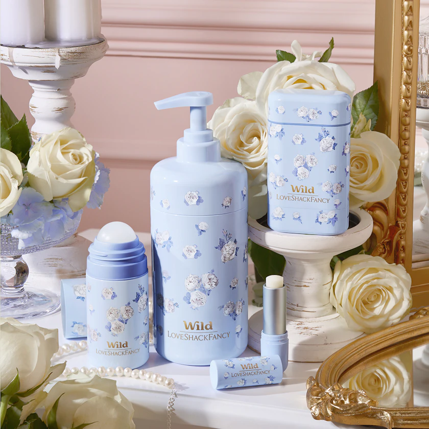 Caption: a table topped with bottles of lotion and flowers