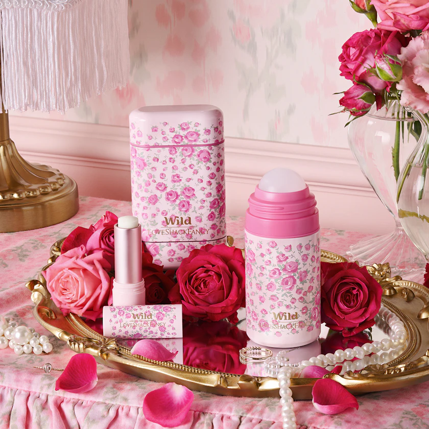 Caption: a tray with pink flowers and lipstick on it