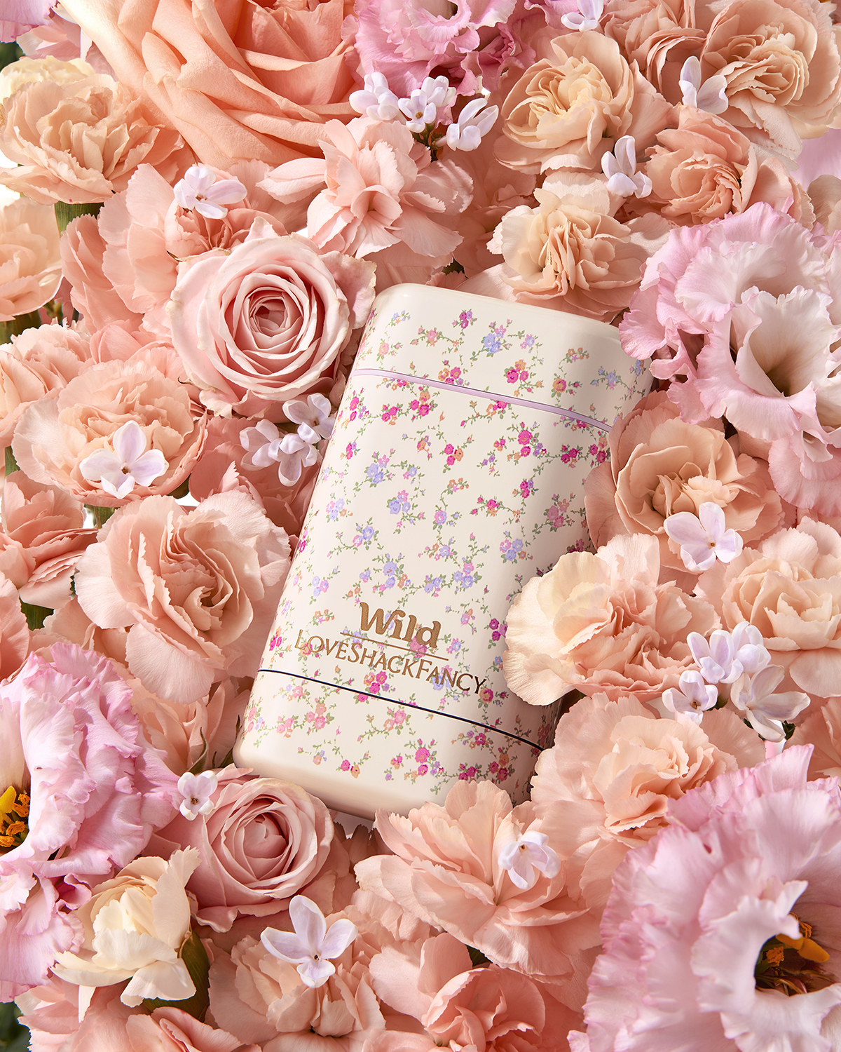 Caption: a white notebook surrounded by pink flowers