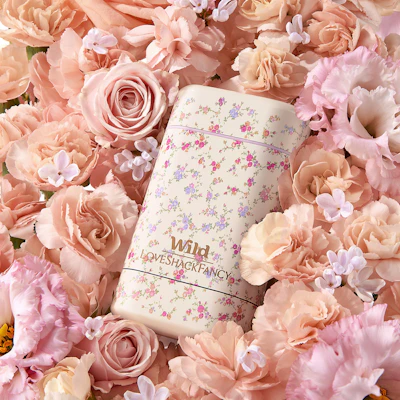Caption: a white notebook surrounded by pink flowers