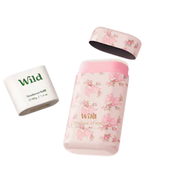 Caption: a bottle of wild deodorant next to a roll of deodoran