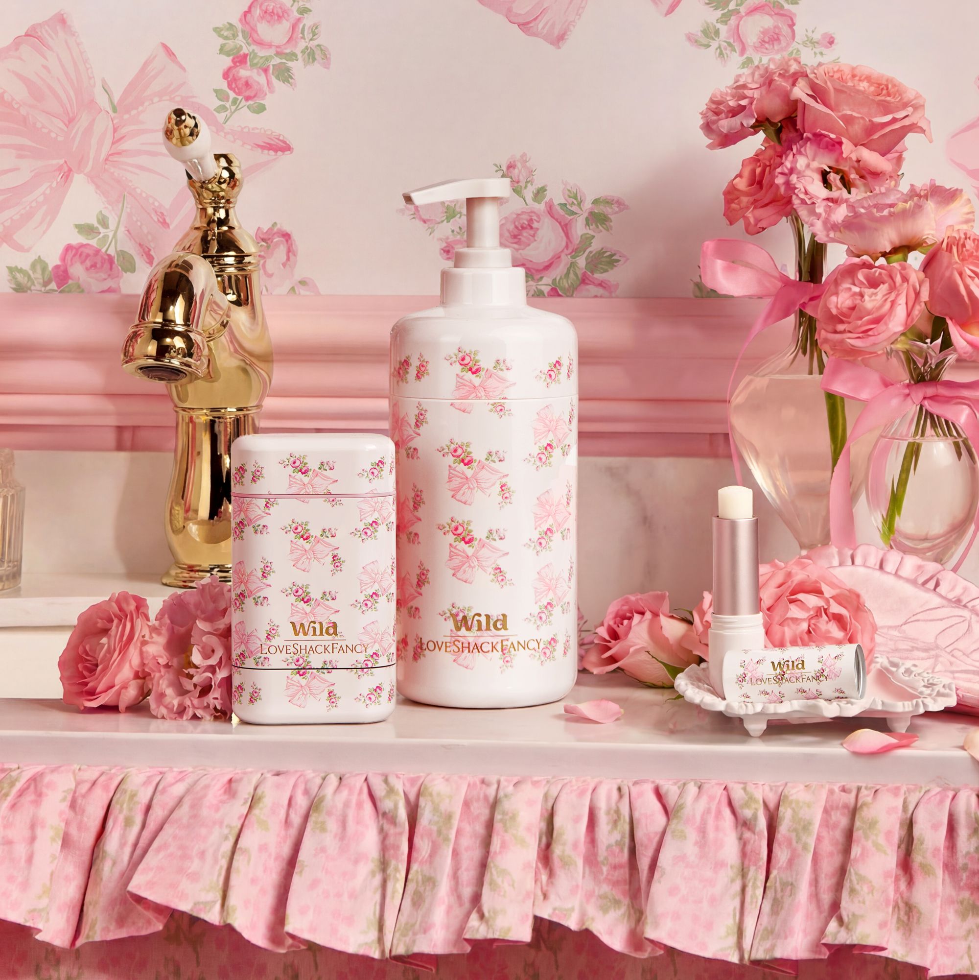 Caption: a table topped with a bottle of lotion next to a vase of flowers