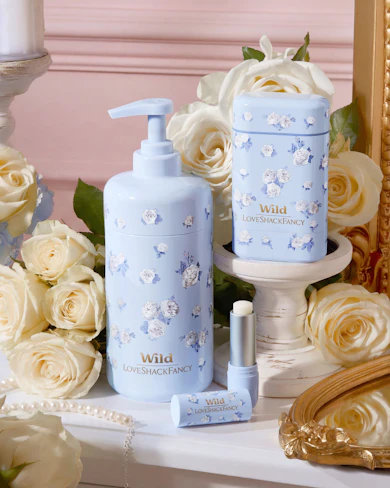 Caption: a table topped with a bottle of lotion next to a mirror