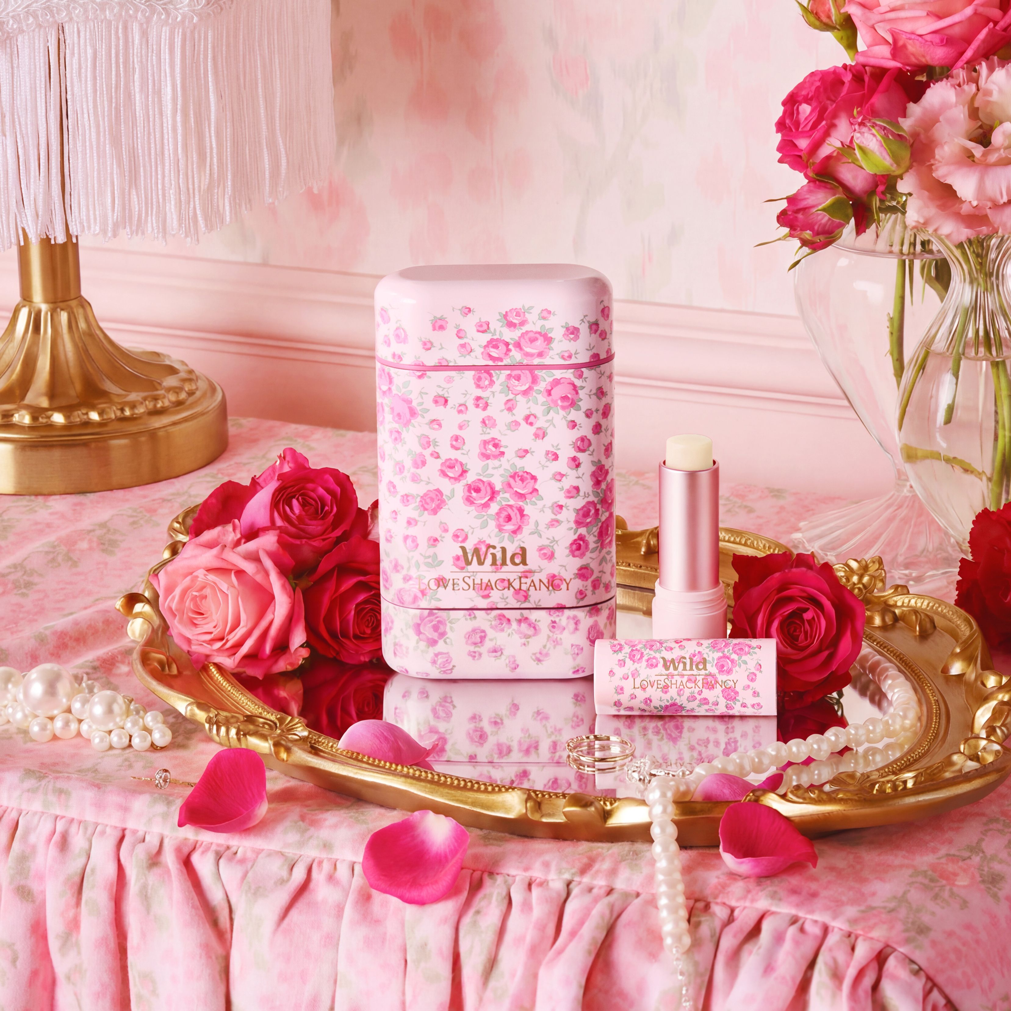 Caption: a pink table with pink flowers and pink lipstick