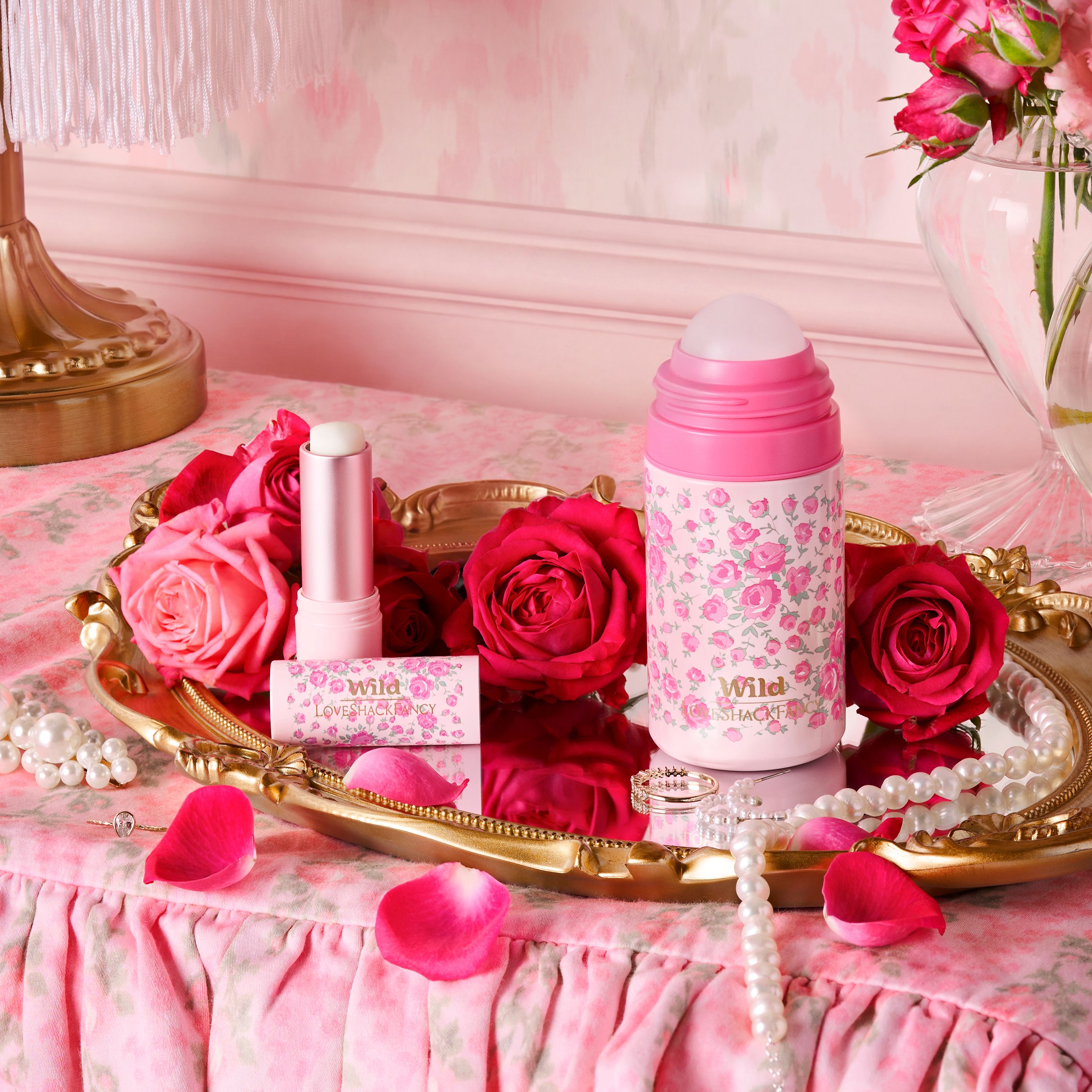 Caption: a tray with pink roses and lipstick on it