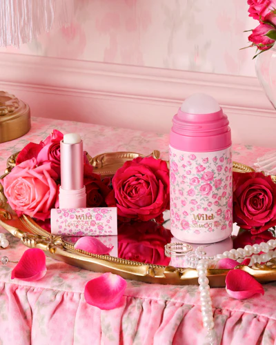 Caption: a tray with pink roses and lipstick on it