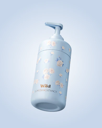 Caption: a white and blue bottle with flowers on it
