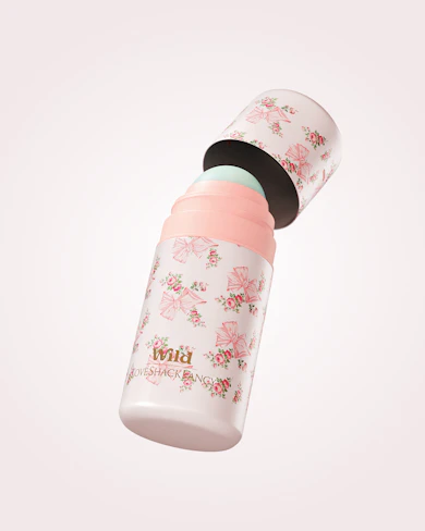 Caption: a pink and white baby bottle with a black lid