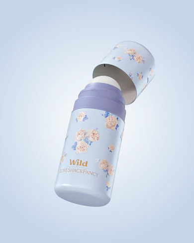 Caption: a white and blue bottle with flowers on it