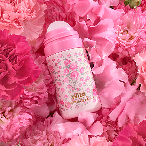 Caption: a pink water bottle sitting on top of pink flowers