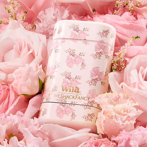 Caption: a pink floral arrangement with a pink and white coffee mug