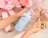 Caption: a woman is washing her hands with a blue bottle