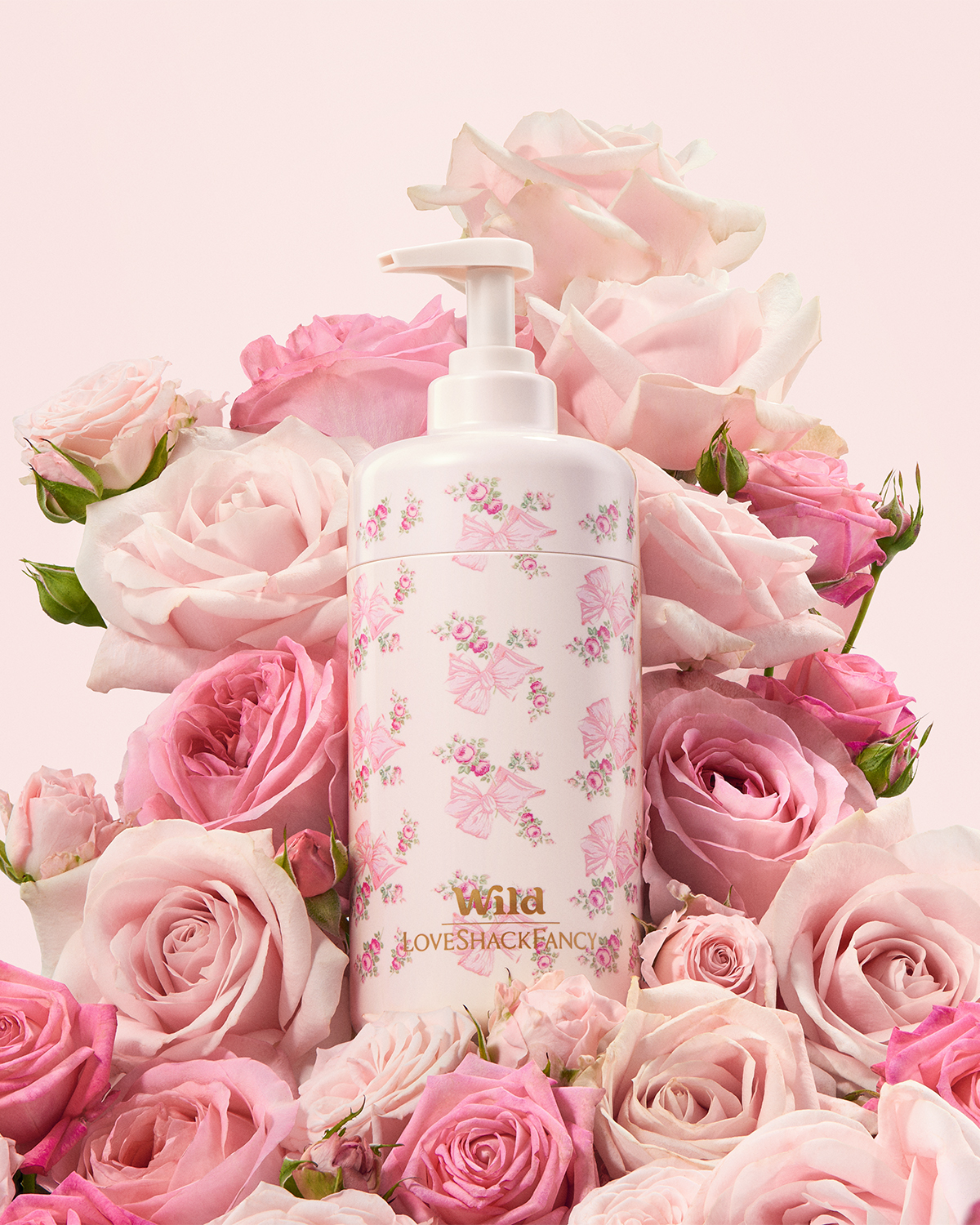 Caption: a bottle of lotion surrounded by pink roses