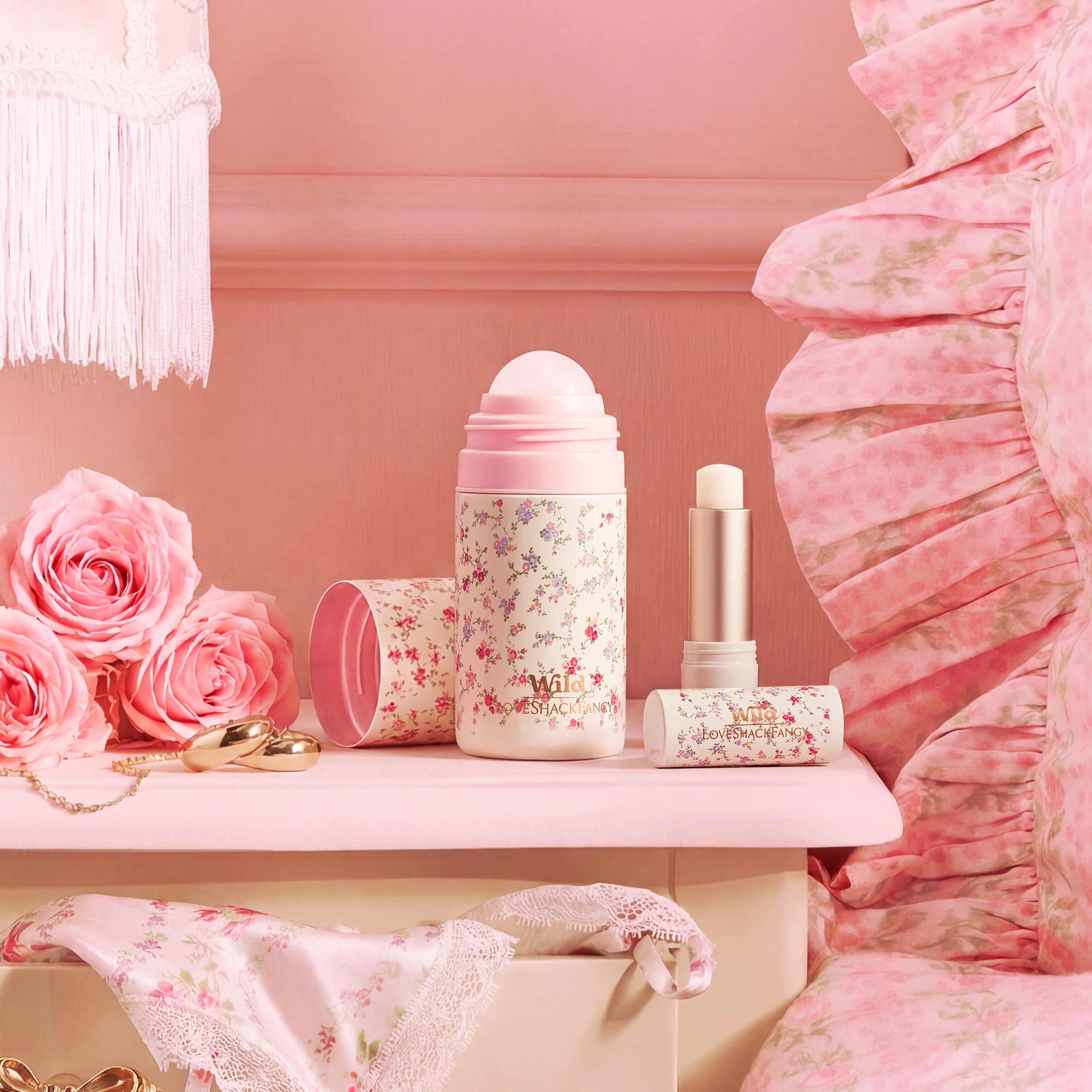 Caption: a pink dresser with pink flowers and a bottle of lipstick