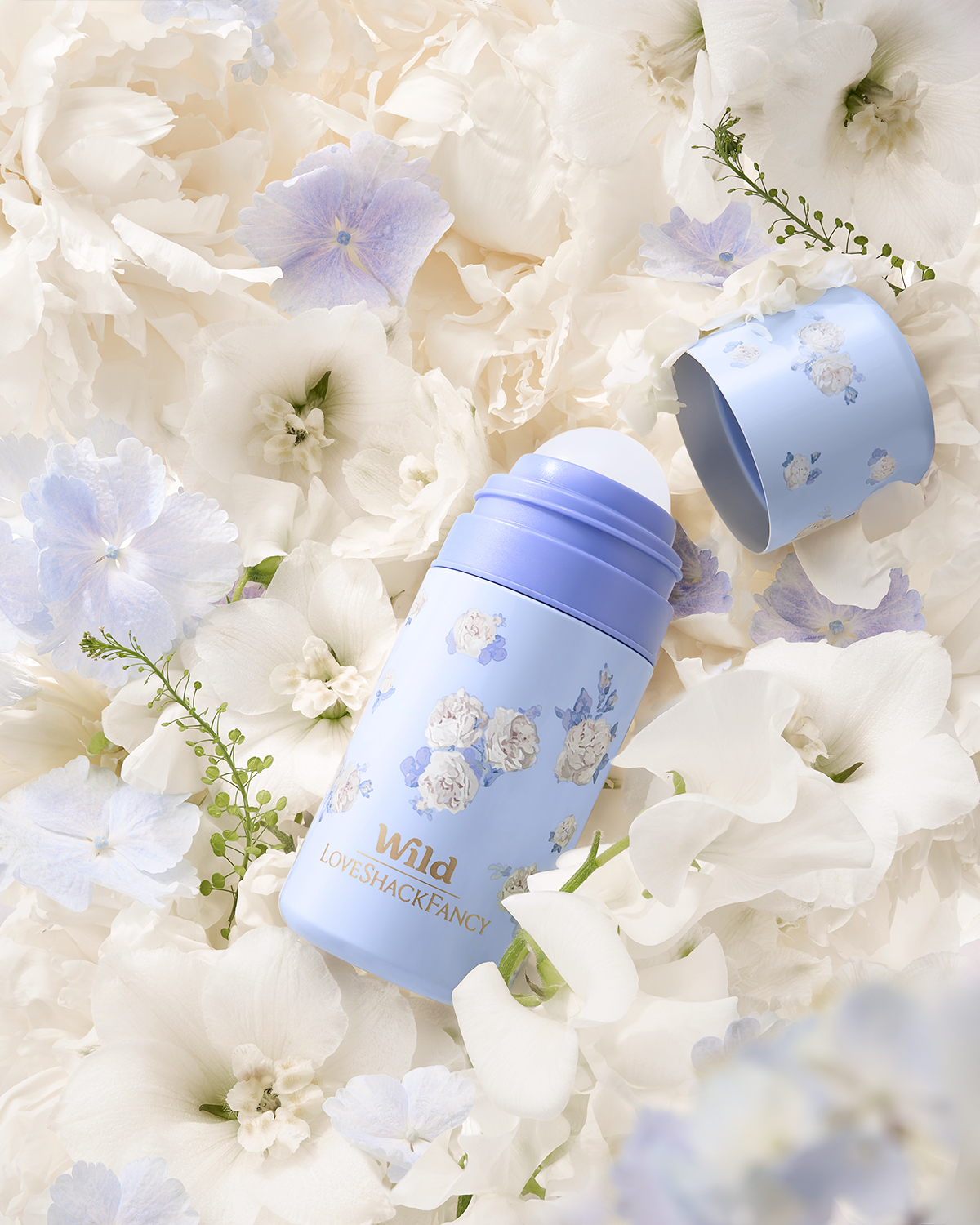 Caption: a close up of a blue bottle on a bed of flowers