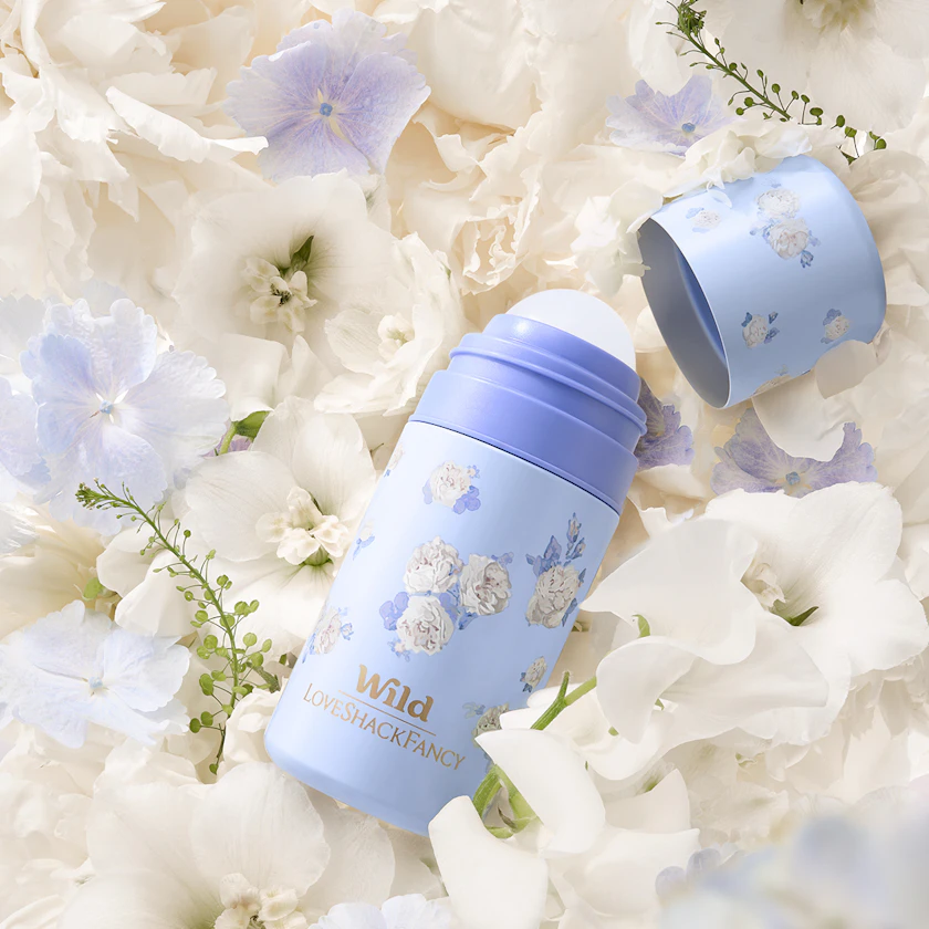 Caption: a close up of a blue bottle on a bed of flowers