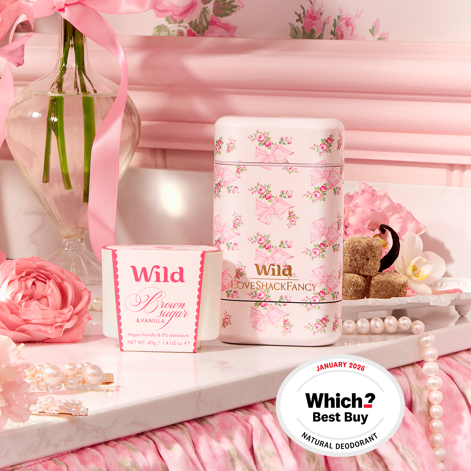 Caption: a table topped with a bottle of perfume next to a vase of flowers