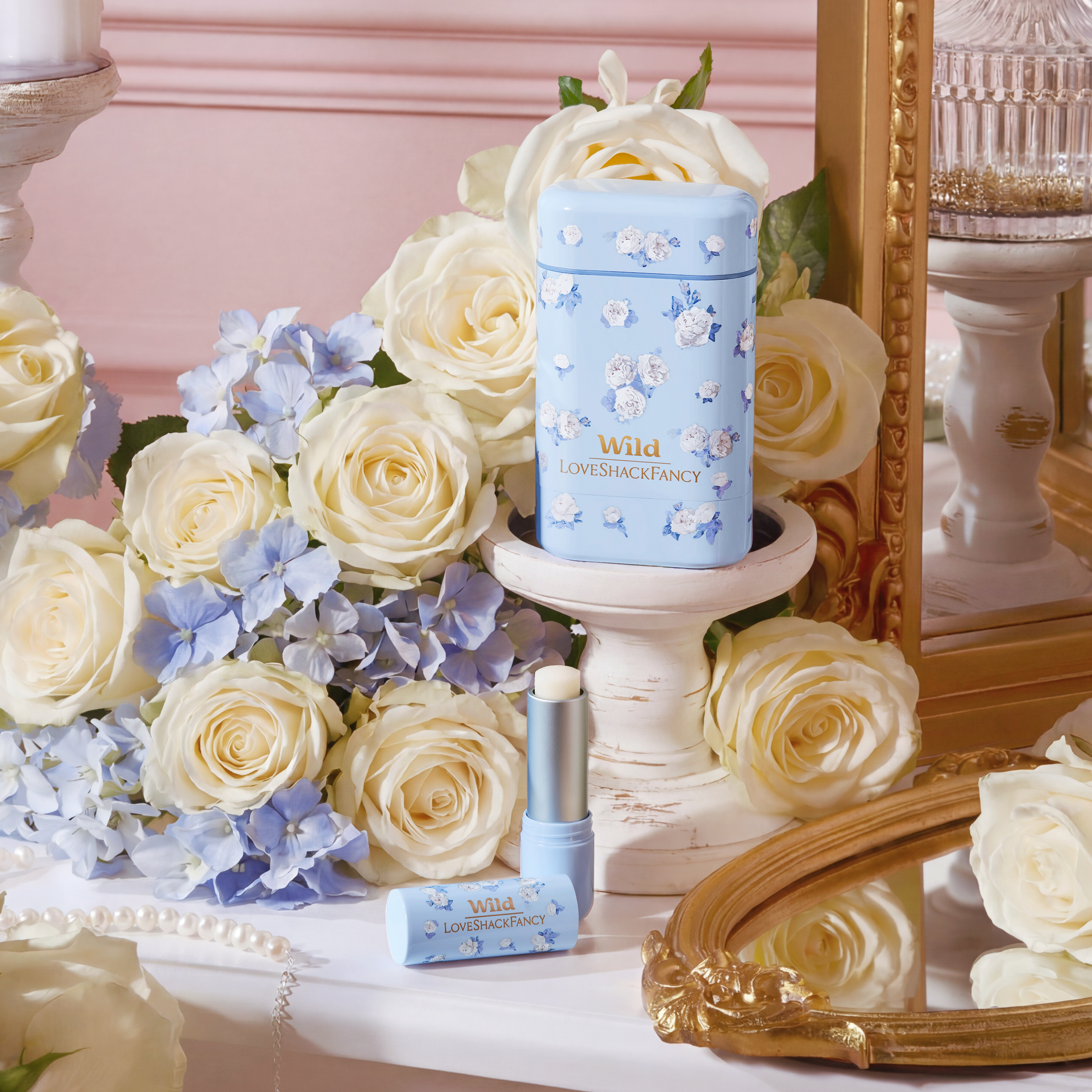 Caption: a bouquet of white roses next to a blue and white candle