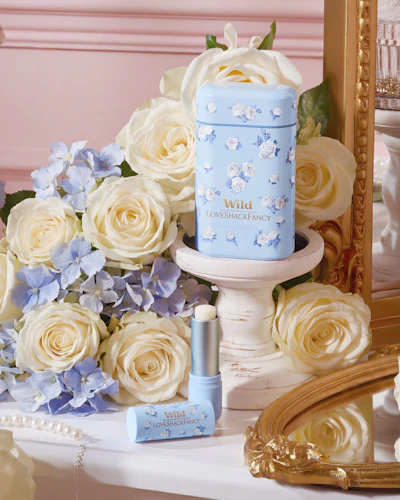 Caption: a bouquet of white roses next to a blue and white candle