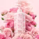 Caption: a bottle of lotion surrounded by pink roses