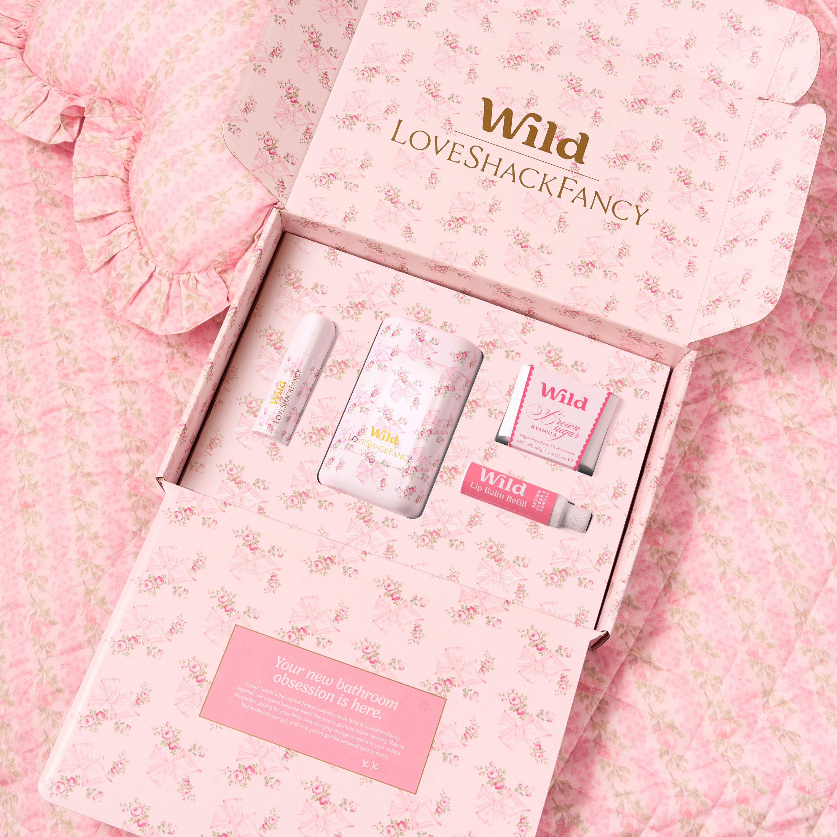 Caption: a pink box with a lot of different items inside of it